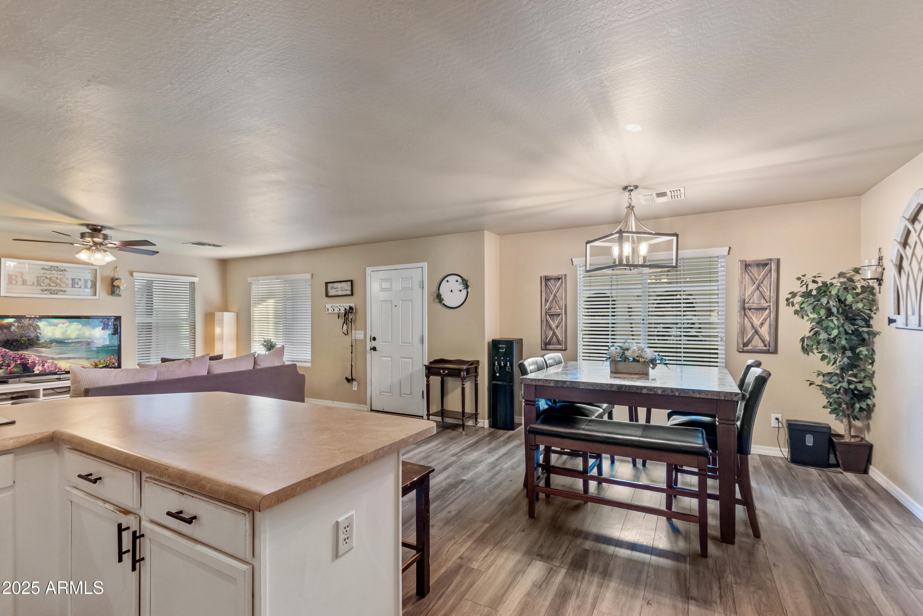 878 South Huish Drive, Unit LOT 105 Gilbert, AZ 85296 - Photo 5 of 51 a kitchen with a table chairs and wooden floor