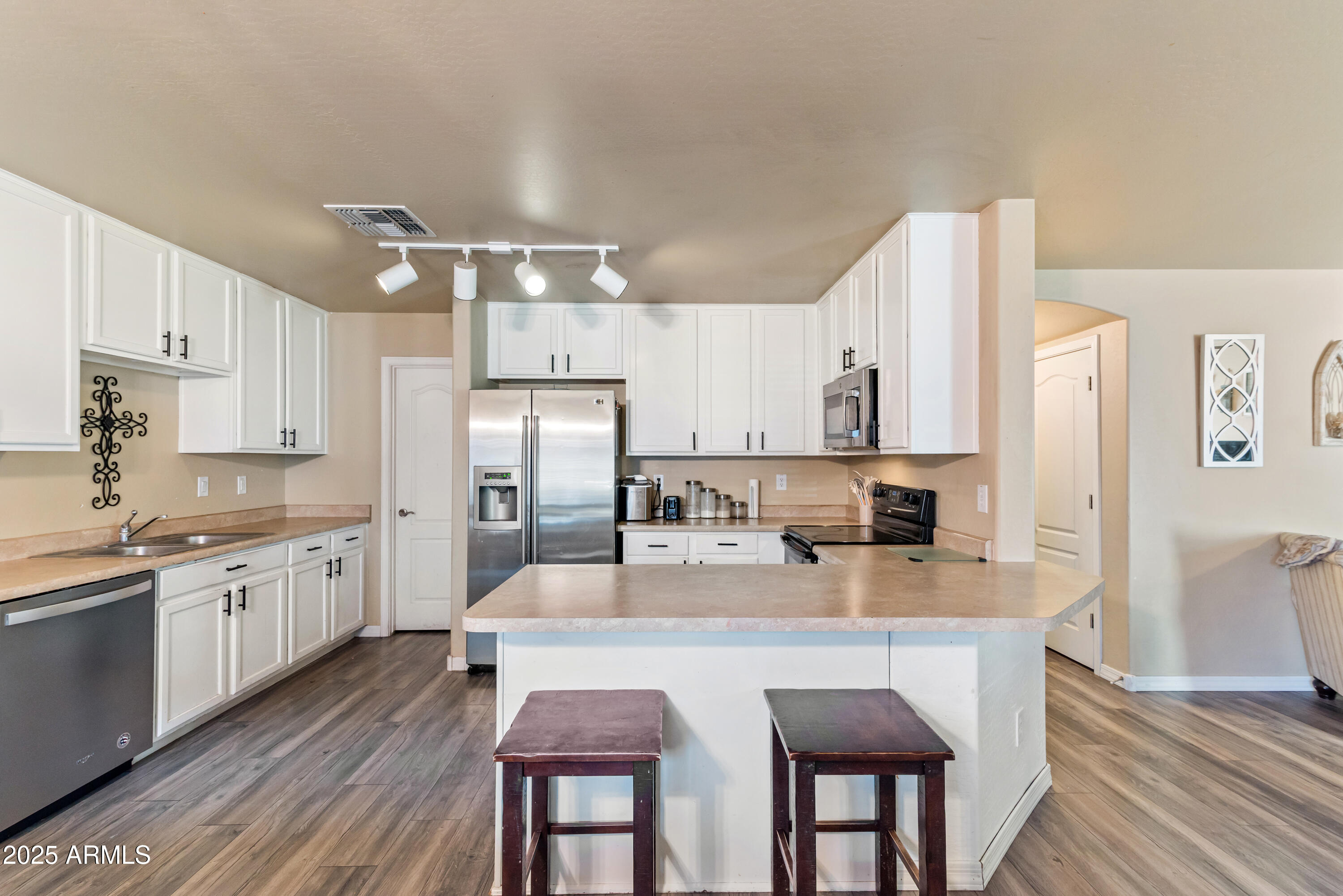 878 South Huish Drive, Unit LOT 105 Gilbert, AZ 85296 - Photo 8 of 51 a large kitchen with granite countertop a center island stainless steel appliances cabinets and wooden floor