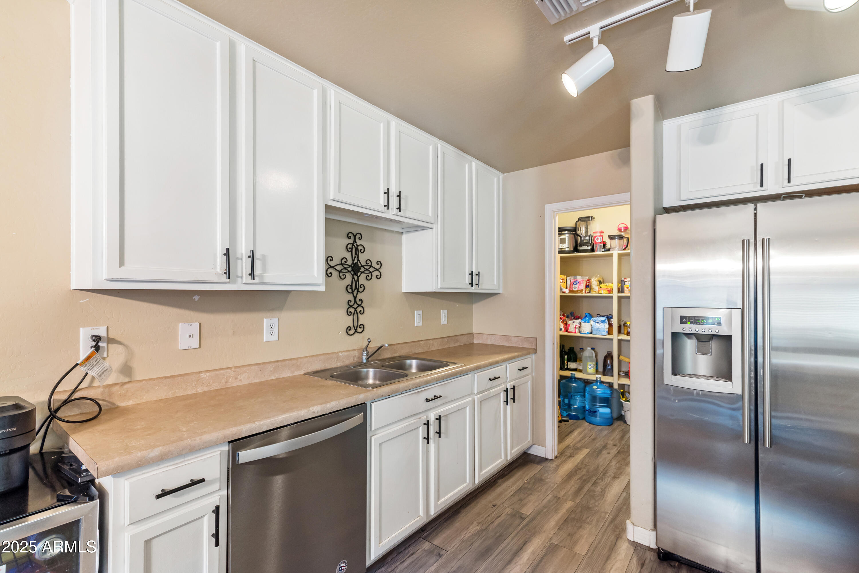 878 South Huish Drive, Unit LOT 105 Gilbert, AZ 85296 - Photo 9 of 51 a kitchen with a sink stainless steel appliances and cabinets