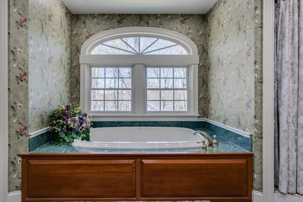 97 Glenwood Road Rutland, MA 01543 - Photo 15 of 26 a bathroom with a granite countertop window a sink and a bathtub