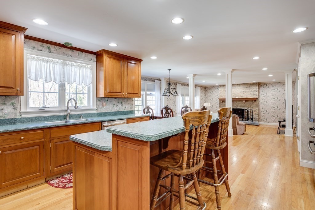 97 Glenwood Road Rutland, MA 01543 - Photo 6 of 26 a kitchen with stainless steel appliances granite countertop table chairs sink and window