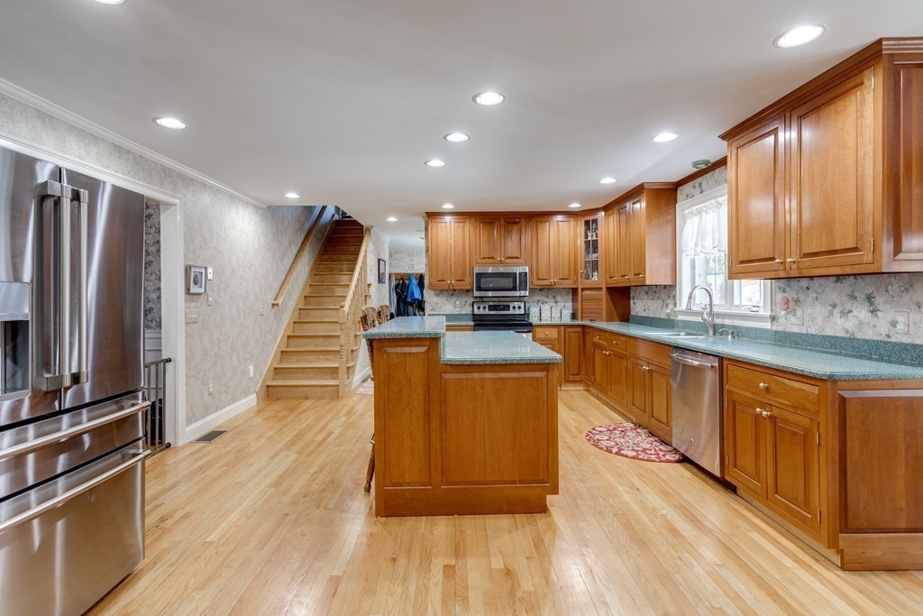 97 Glenwood Road Rutland, MA 01543 - Photo 8 of 26 a kitchen with stainless steel appliances granite countertop a refrigerator a sink dishwasher a stove and a oven with wooden floor