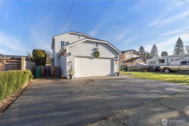 a view of an house with backyard space and balcony