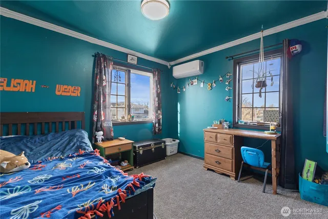 a bedroom with furniture and a window