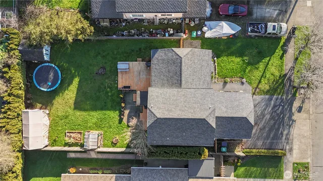 an aerial view of a house with a garden and trees