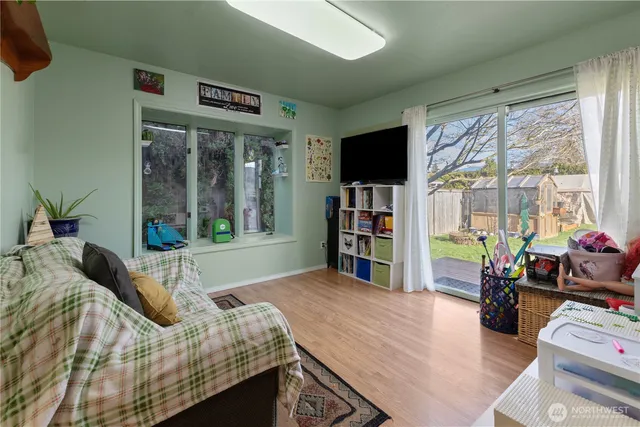 a bedroom with a bed a large window and walk in closet