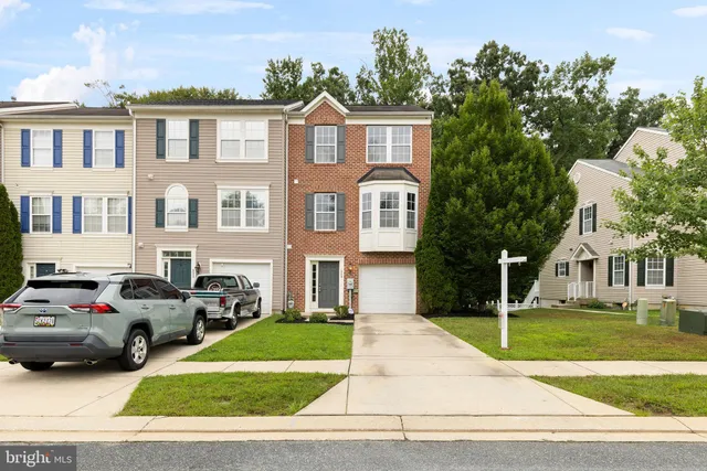 a front view of a residential apartment building with a yard