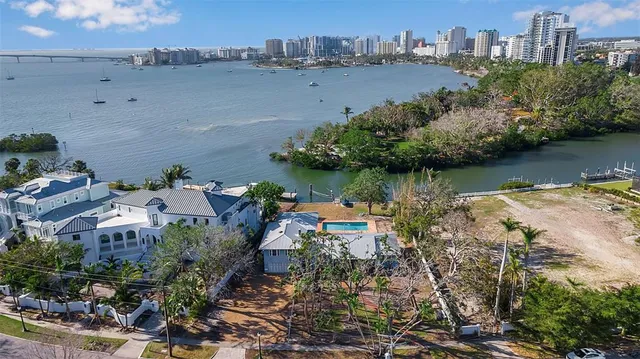 an aerial view of a city with lots of residential buildings lake and ocean view