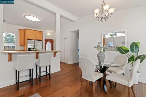 a dining room with furniture a window and wooden floor