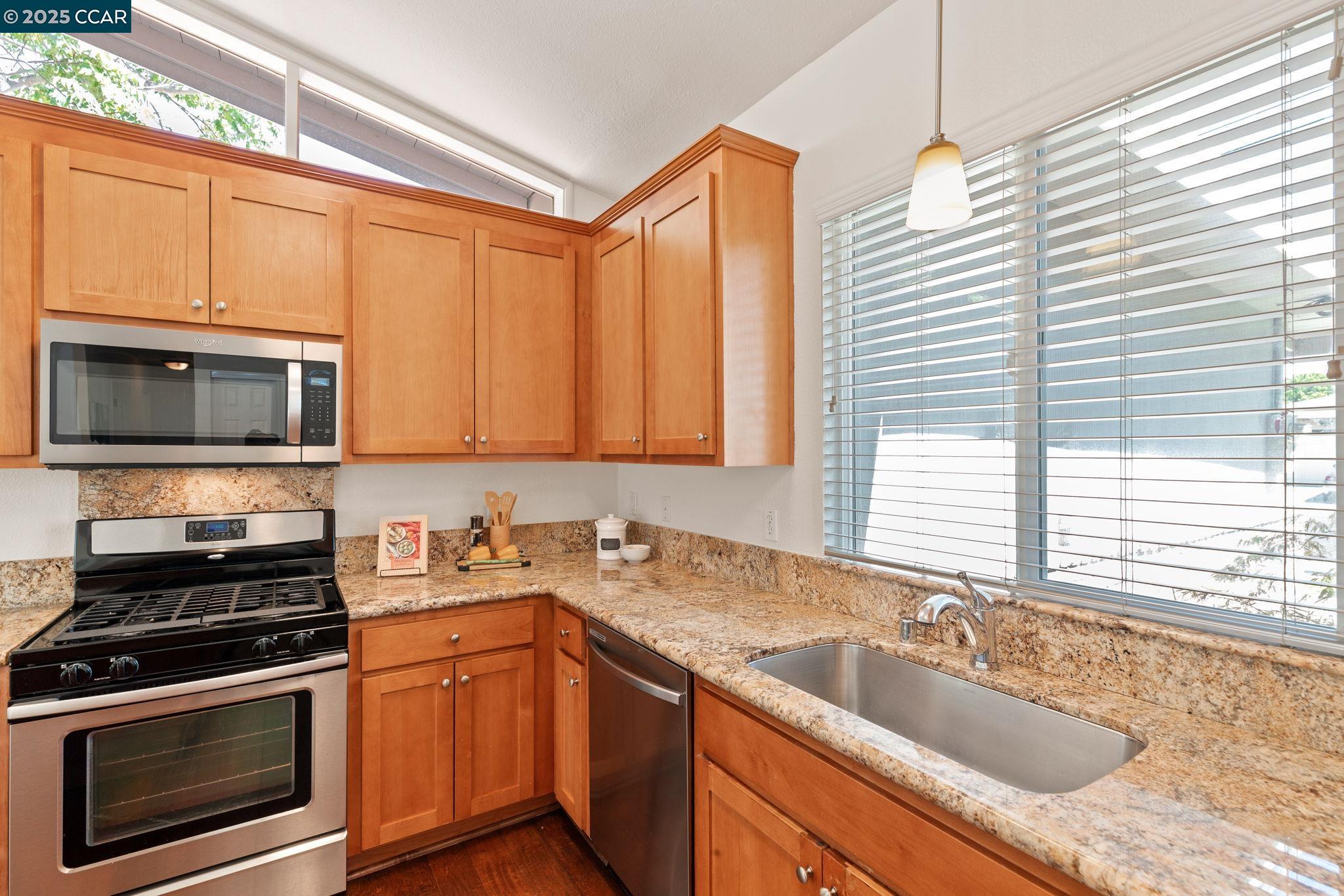 3249 Claudia Drive Concord, CA 94519 - Photo 14 of 34 a kitchen with granite countertop a sink a stove and cabinets