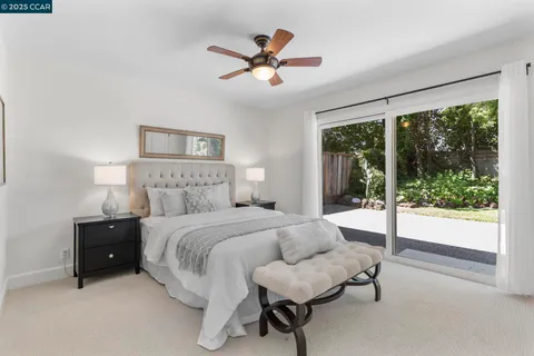 a spacious bedroom with a bed and a large window