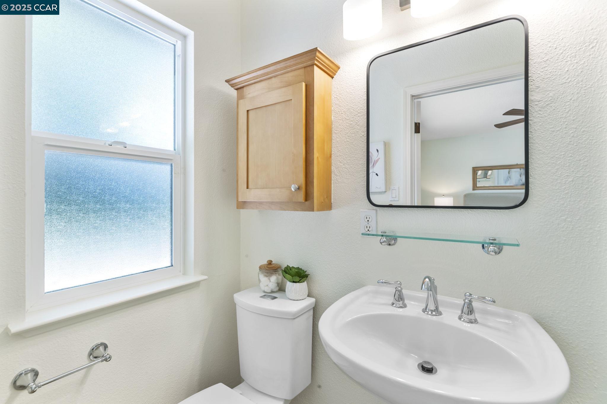 3249 Claudia Drive Concord, CA 94519 - Photo 21 of 34 a bathroom with a toilet a sink and mirror