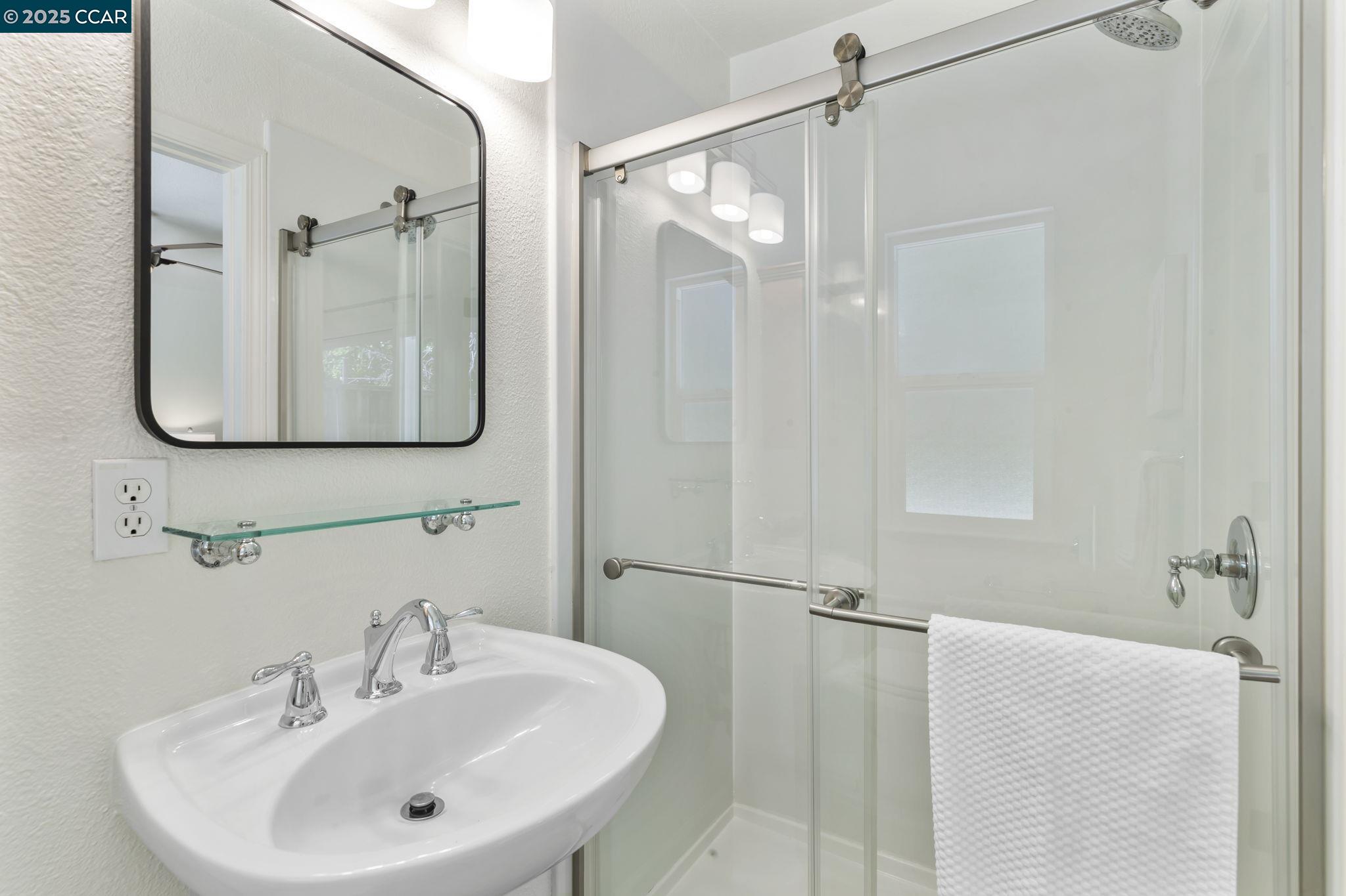 3249 Claudia Drive Concord, CA 94519 - Photo 22 of 34 a bathroom with a sink a glass door and shower