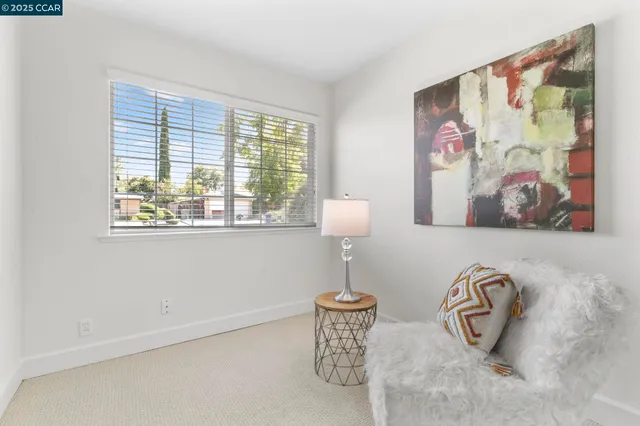 a bedroom with a bed and a lamp on table
