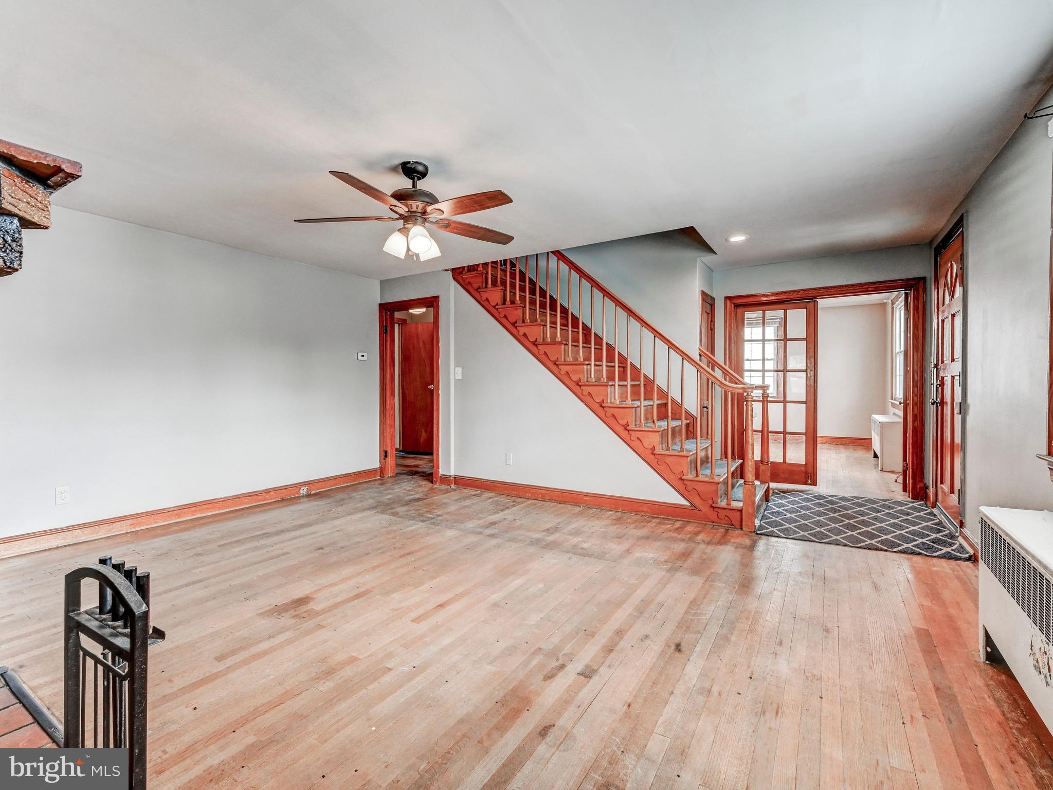 3206 Lynch Road Baltimore, MD 21219 - Photo 11 of 70 a view of an empty room with wooden floor and a ceiling fan