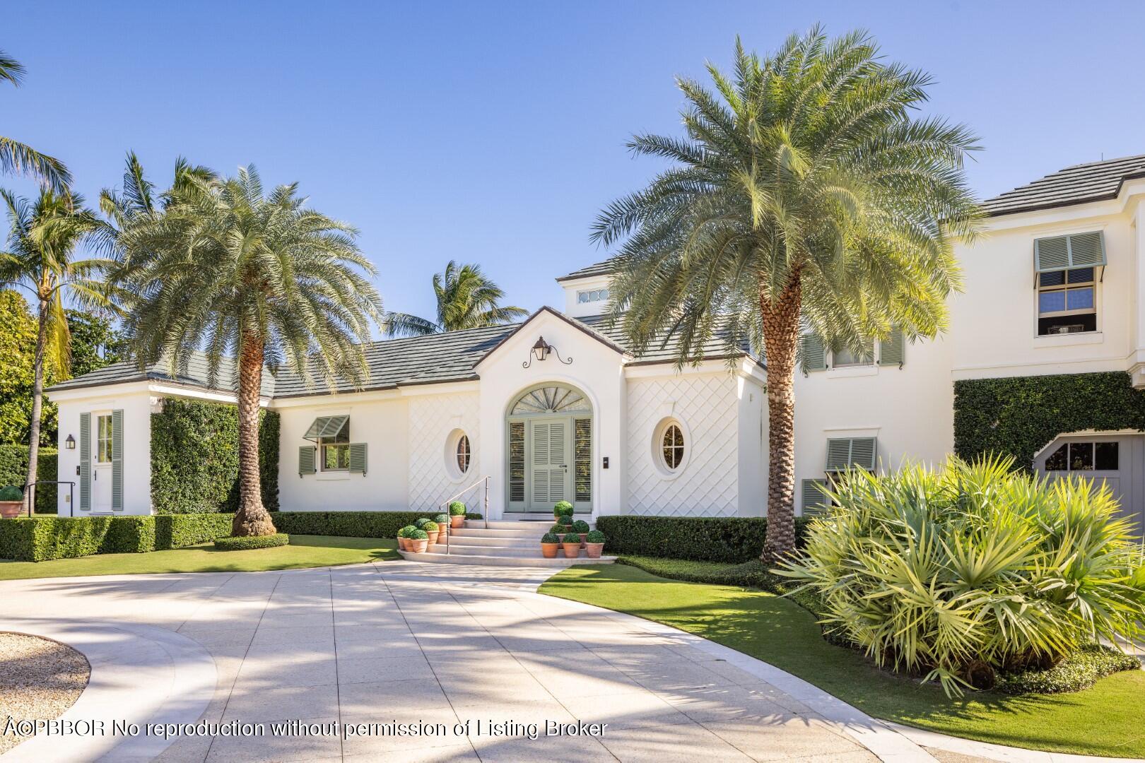710 South County Road Palm Beach, FL 33480 - Photo 14 of 69 a view of a white house with a large tree and plants