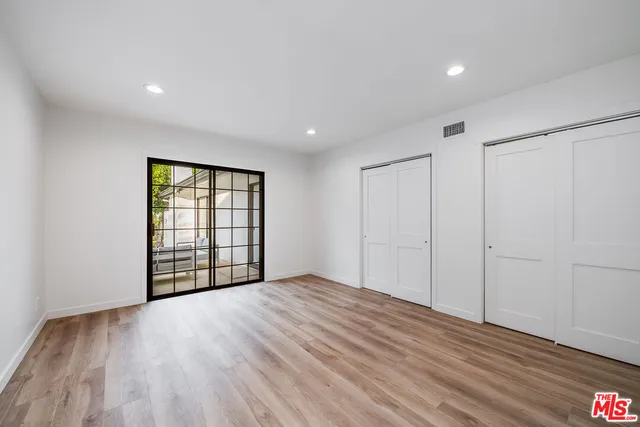 a living room with fireplace furniture and a large window