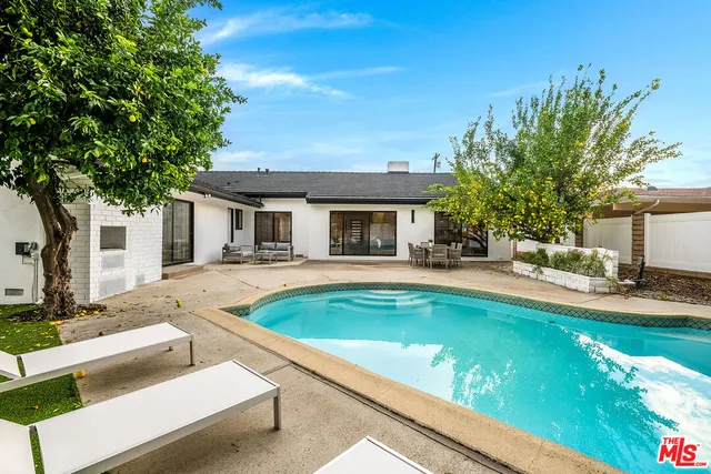 an aerial view of a house with a swimming pool