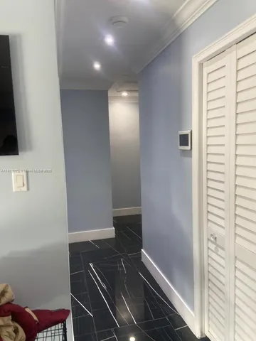 a kitchen with granite countertop a stove and white cabinets