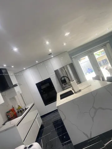 a living room with furniture a window and gym equipment