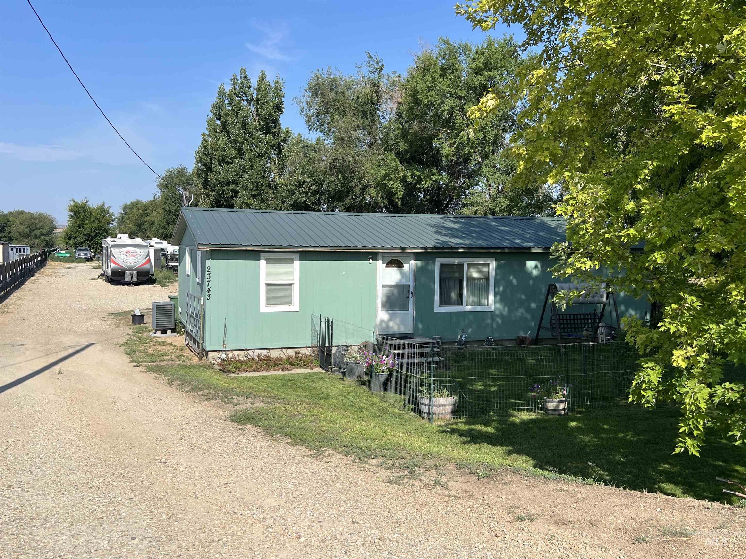 23743 Stephen Lane Parma, ID 83660 - Photo 19 of 34 View of front of property with a metal roof and dirt driveway