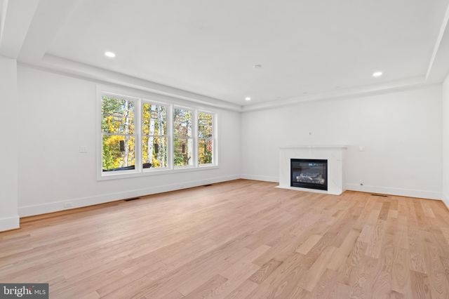 a view of kitchen island a sink windows and wooden floor