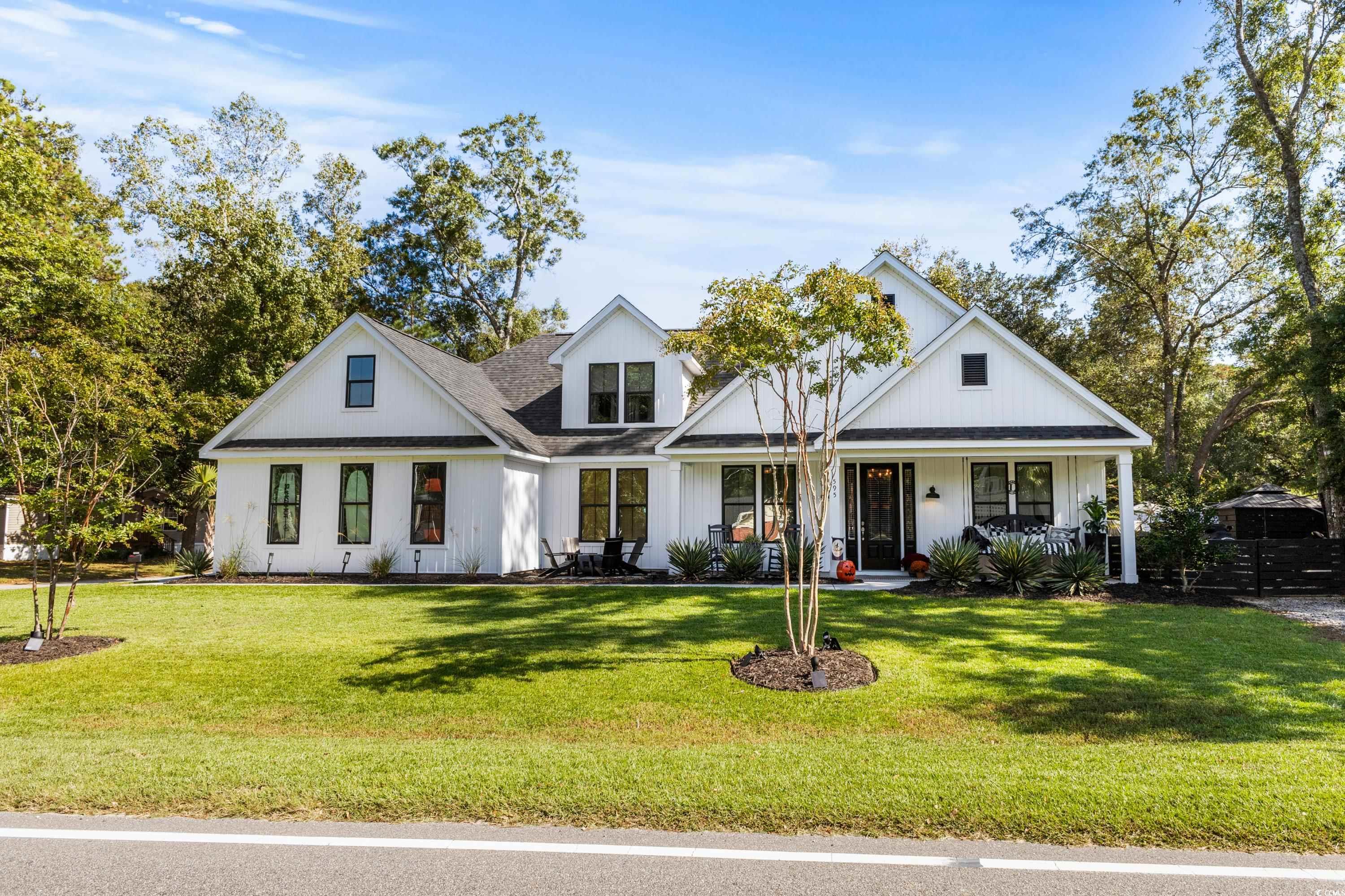 595 Wilcox Avenue Murrells Inlet, SC 29576 - Photo 3 of 40 Modern farmhouse with covered porch, board and bat