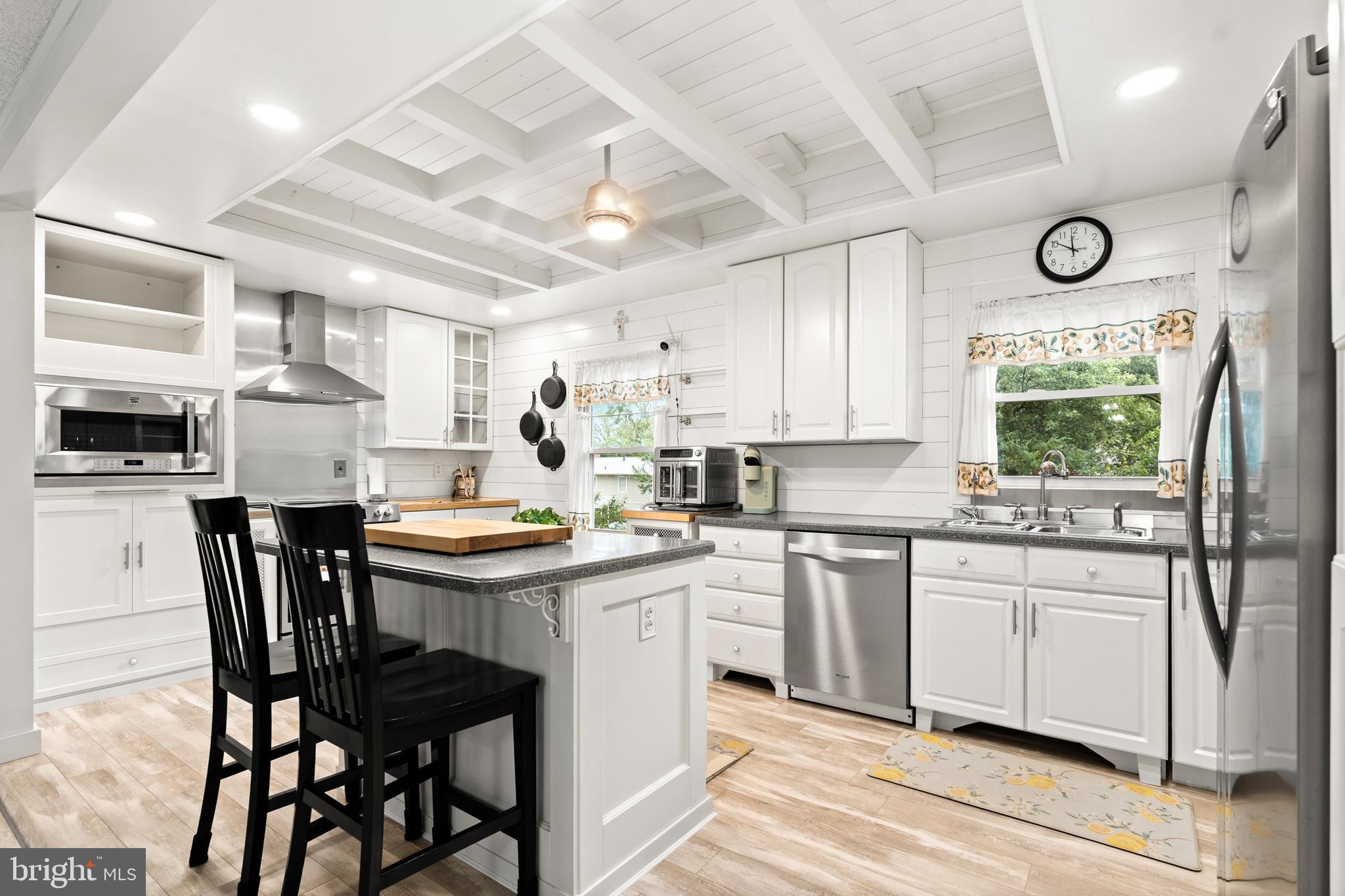 7907 Stone Hearth Road Severn, MD 21144 - Photo 11 of 24 a kitchen with stainless steel appliances granite countertop a table chairs sink and cabinets
