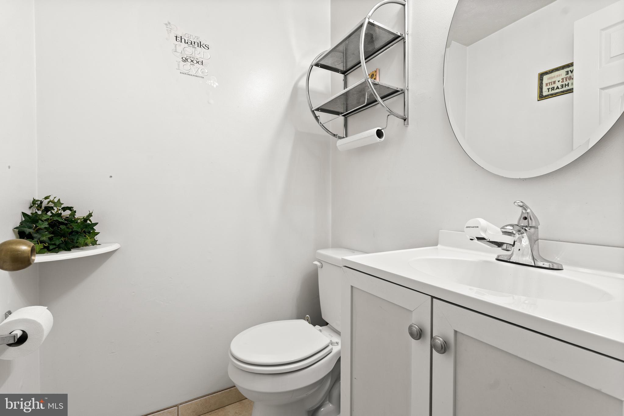7907 Stone Hearth Road Severn, MD 21144 - Photo 23 of 24 a bathroom with a sink toilet and a mirror