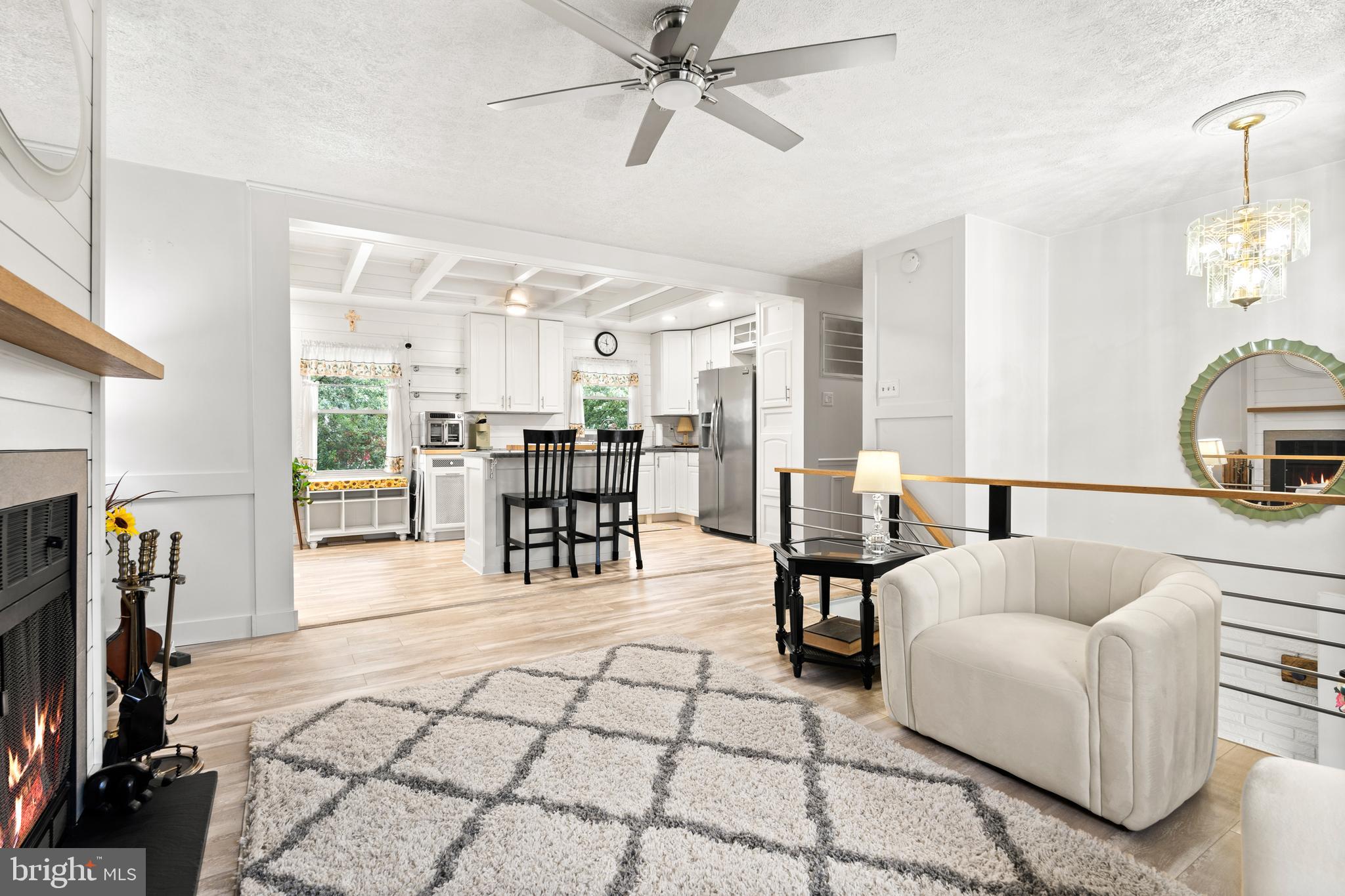 7907 Stone Hearth Road Severn, MD 21144 - Photo 9 of 24 a living room with furniture a dining table and a fireplace
