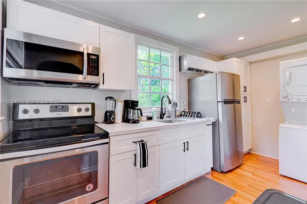 a kitchen with stainless steel appliances a stove microwave and refrigerator