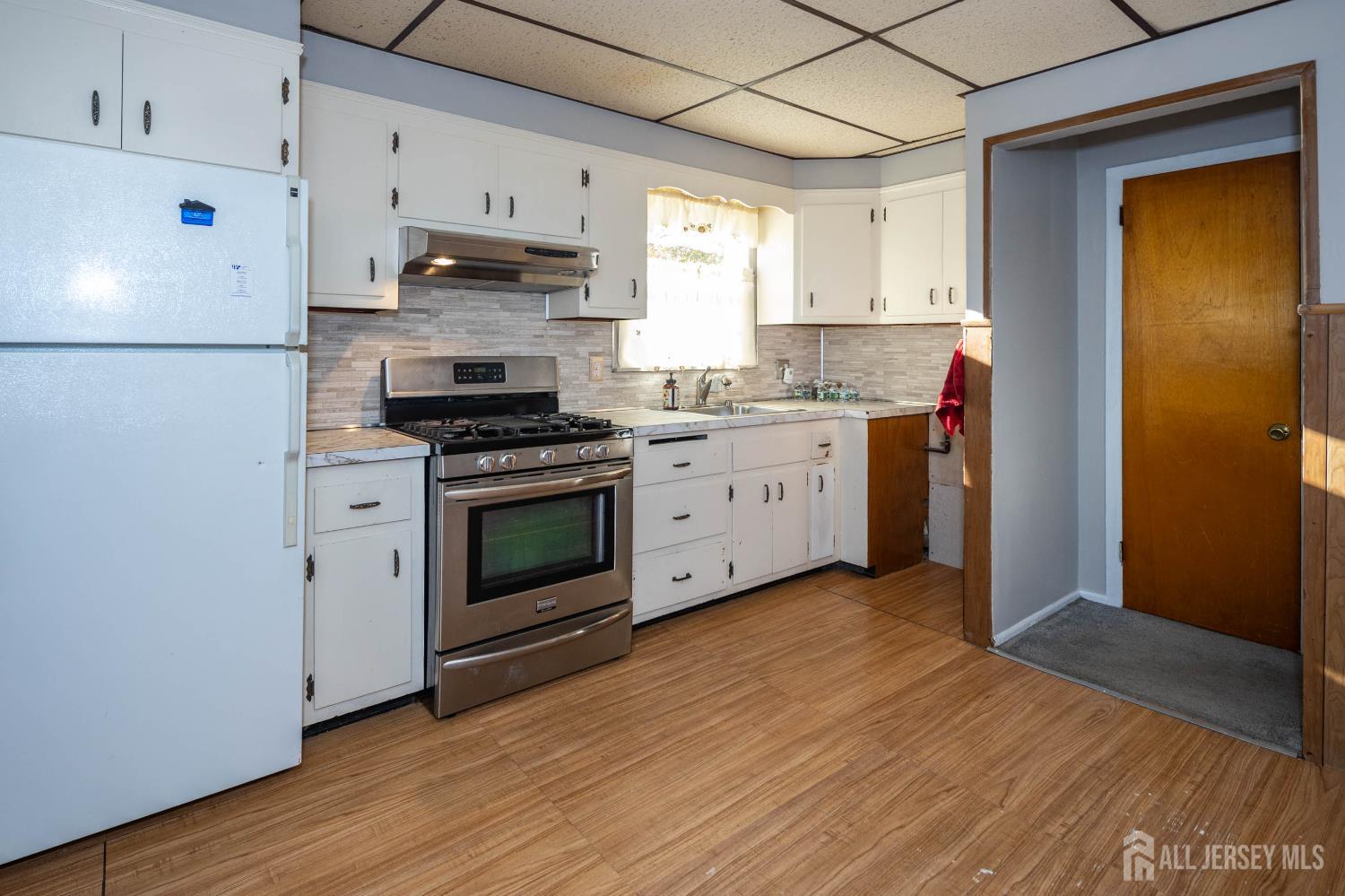 111 Longview Circle Fords, NJ 08863 - Photo 11 of 21 a kitchen with stainless steel appliances granite countertop a stove a sink and a refrigerator