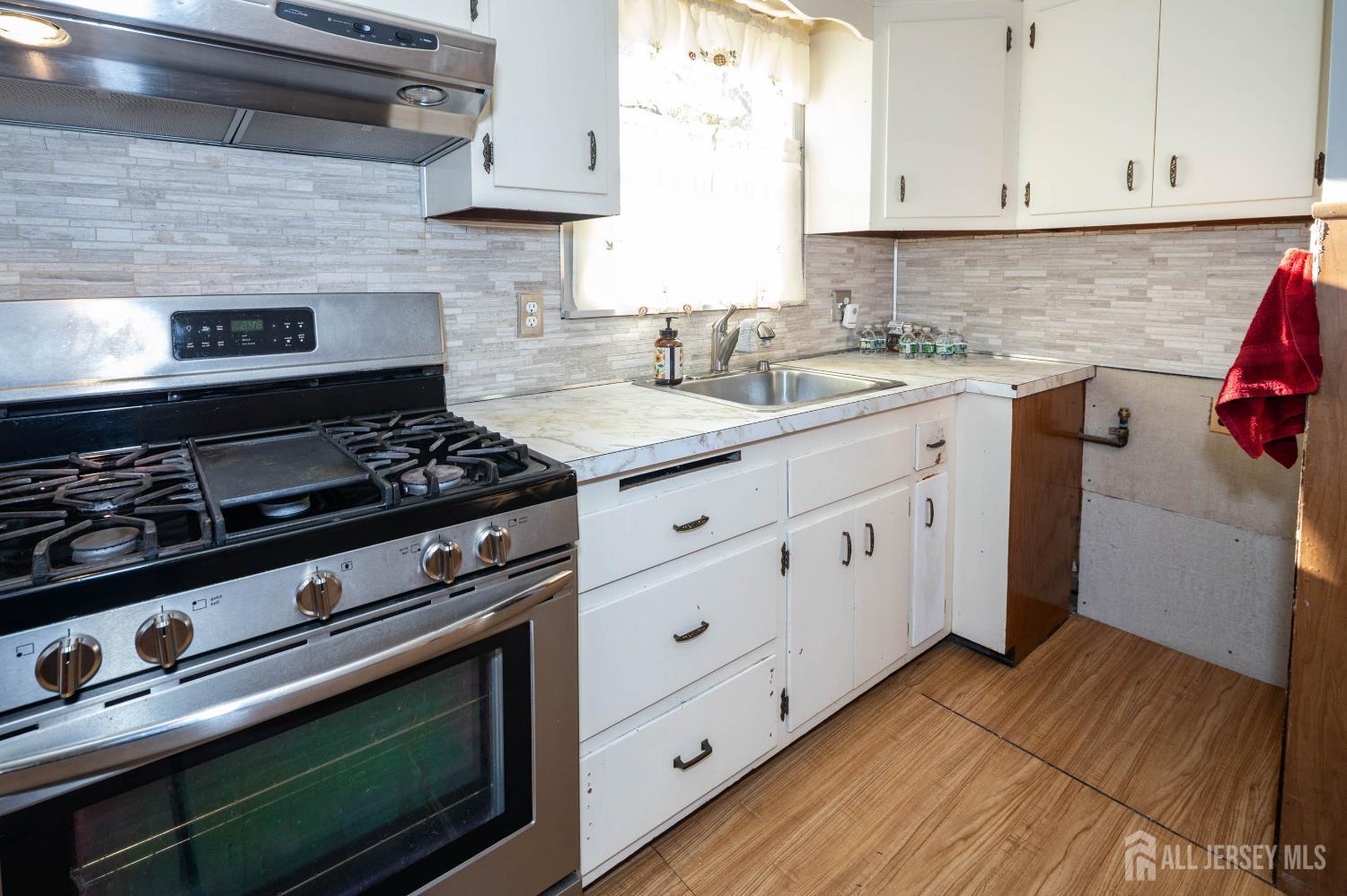 111 Longview Circle Fords, NJ 08863 - Photo 10 of 21 a kitchen with granite countertop a stove and a sink