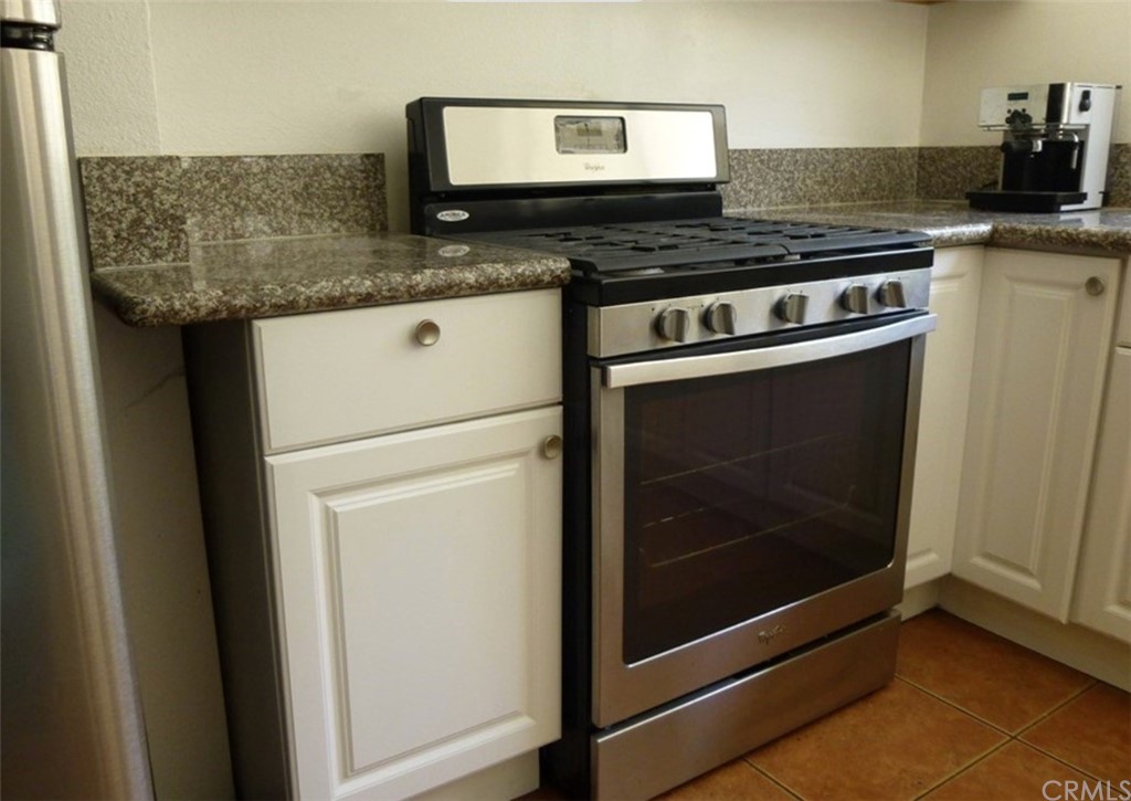53 Carver Irvine, CA 92620 - Photo 5 of 12 a stove top oven sitting inside of a kitchen