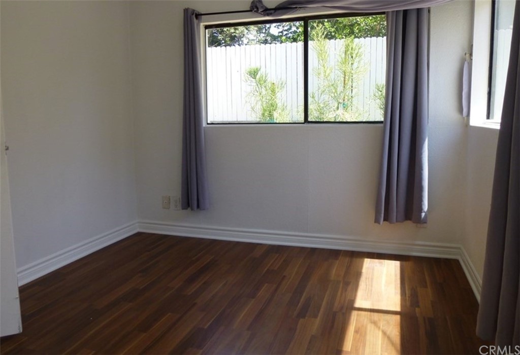 53 Carver Irvine, CA 92620 - Photo 8 of 12 an empty room with wooden floor and windows