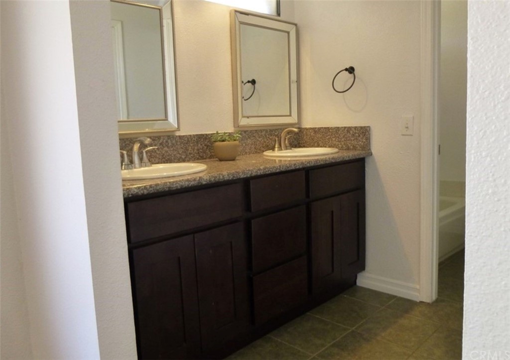 53 Carver Irvine, CA 92620 - Photo 9 of 12 a bathroom with a double vanity sink and a mirror