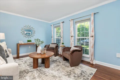 a view of a room with wooden floor and windows