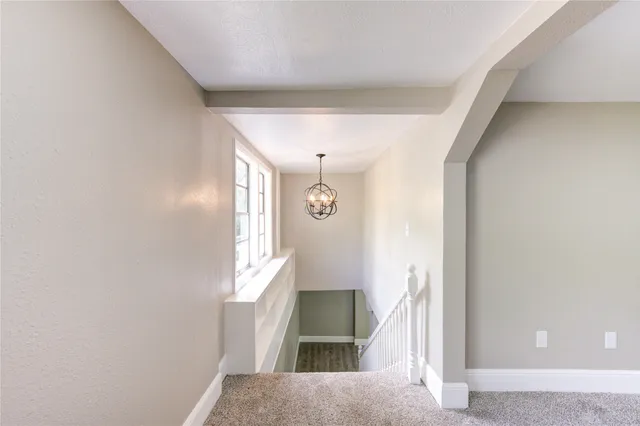 a view of a hallway with windows and entryway