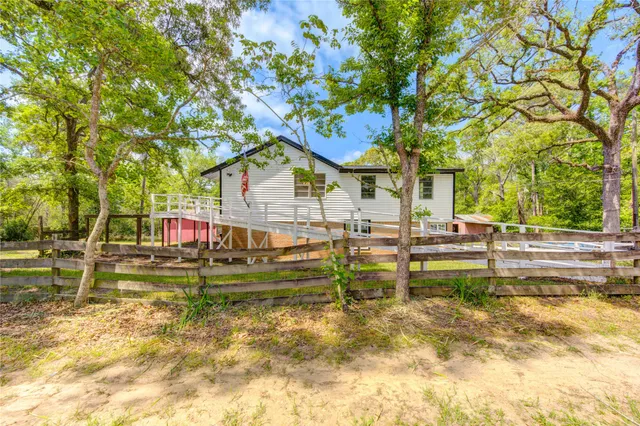 a view of backyard with swimming pool and seating space