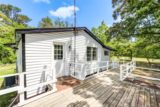a view of balcony with wooden floor and fence