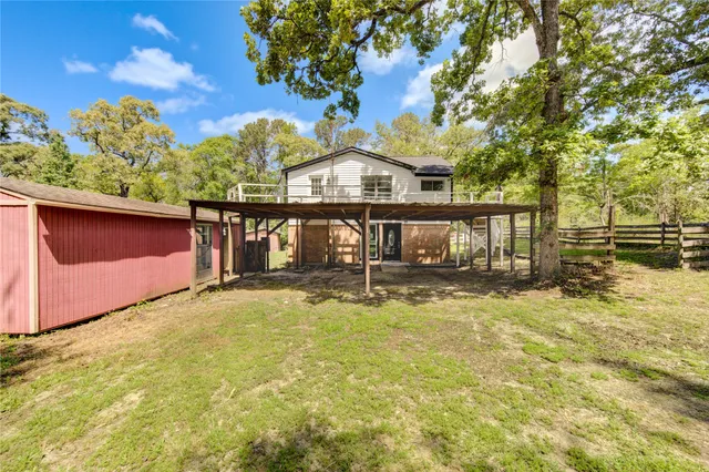 a front view of a house with a yard with swimming pool