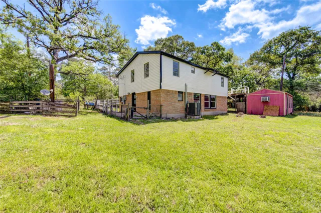 a front view of a house with yard and swimming pool