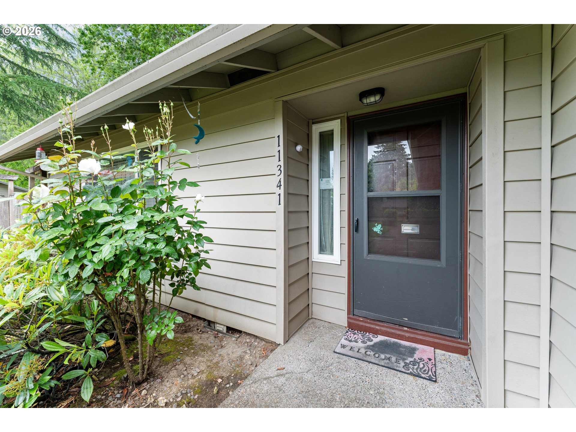 11341 Southwest Springwood Drive Portland, OR 97223 - Photo 3 of 26 a side view of a house with a yard