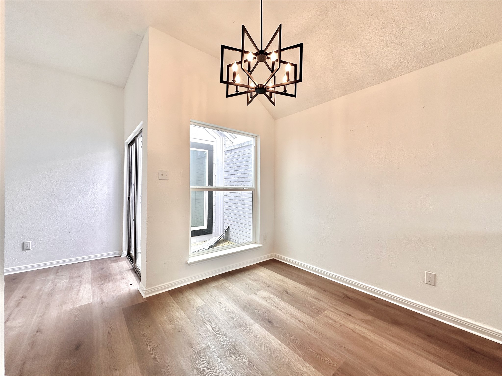 16411 Gold Ridge Lane Houston, TX 77053 - Photo 13 of 25 an empty room with wooden floor mirror and windows