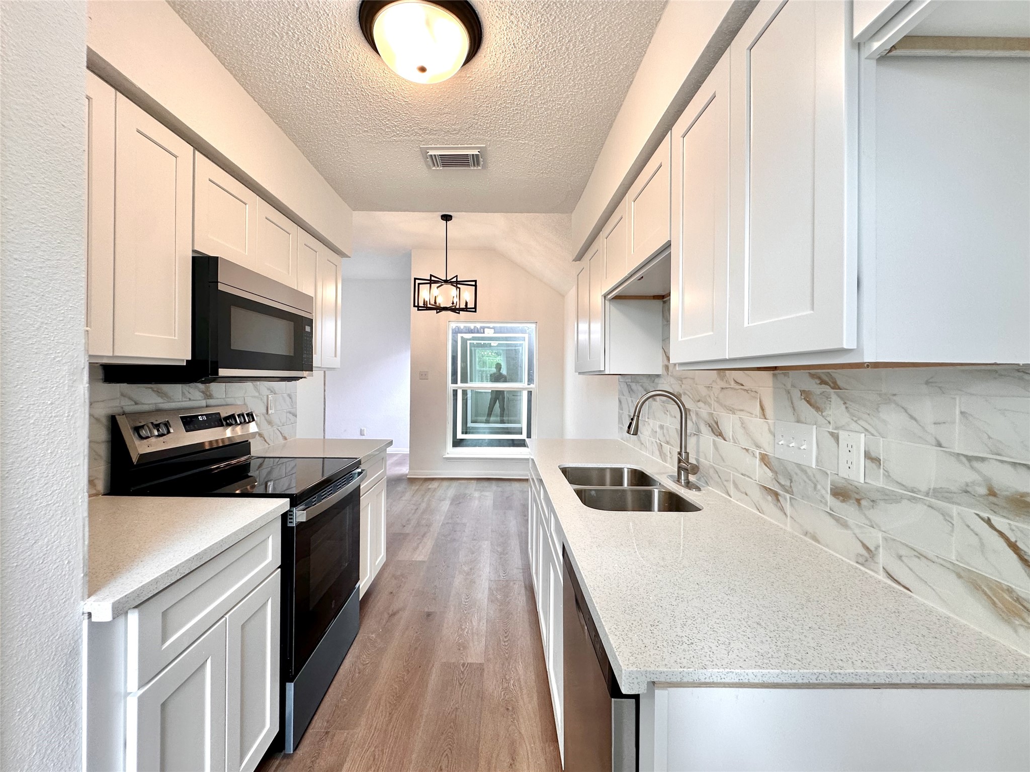 16411 Gold Ridge Lane Houston, TX 77053 - Photo 15 of 25 a kitchen with granite countertop a sink wooden floor and stainless steel appliances