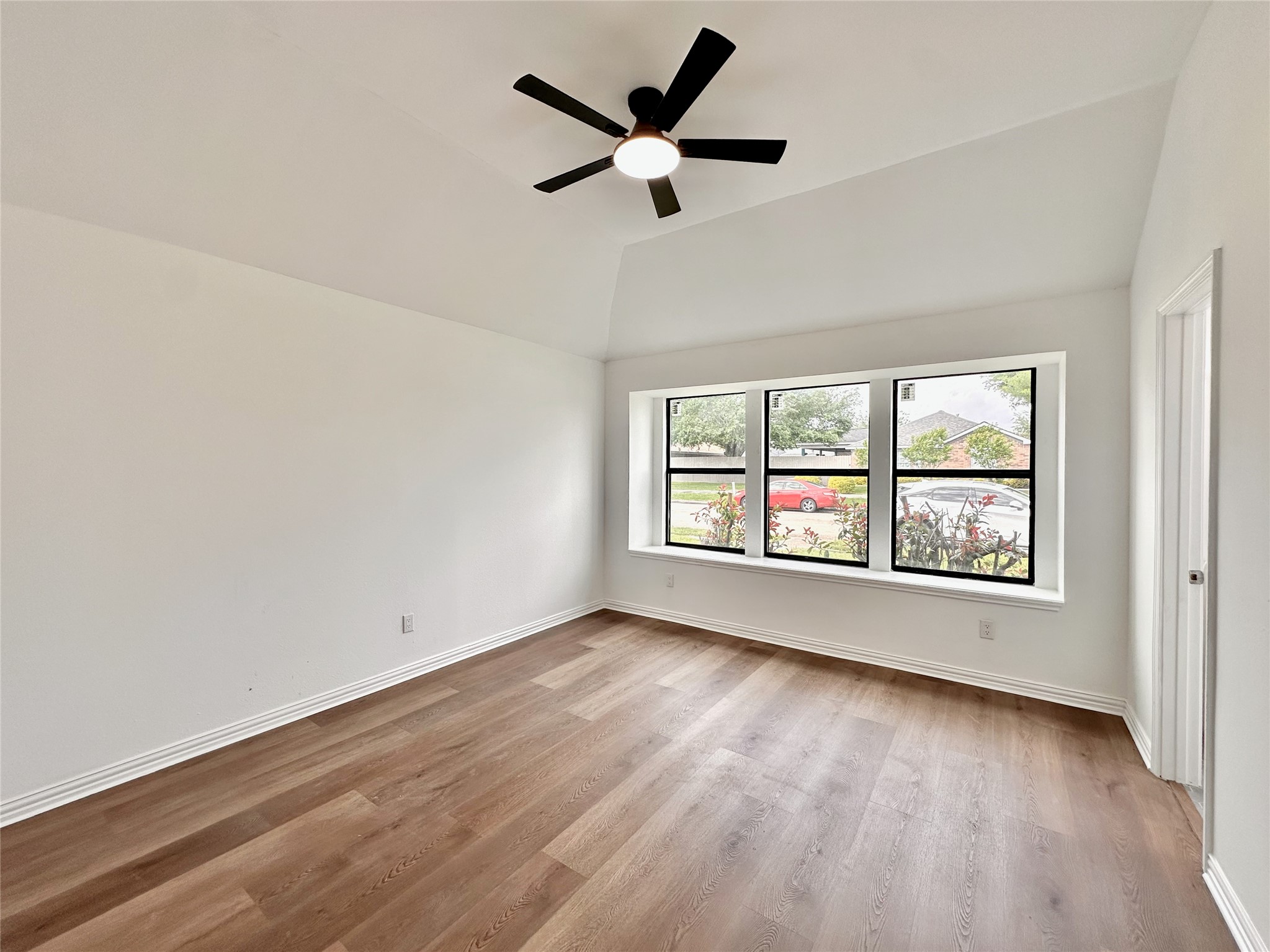 16411 Gold Ridge Lane Houston, TX 77053 - Photo 16 of 25 an empty room with wooden floor fan and windows