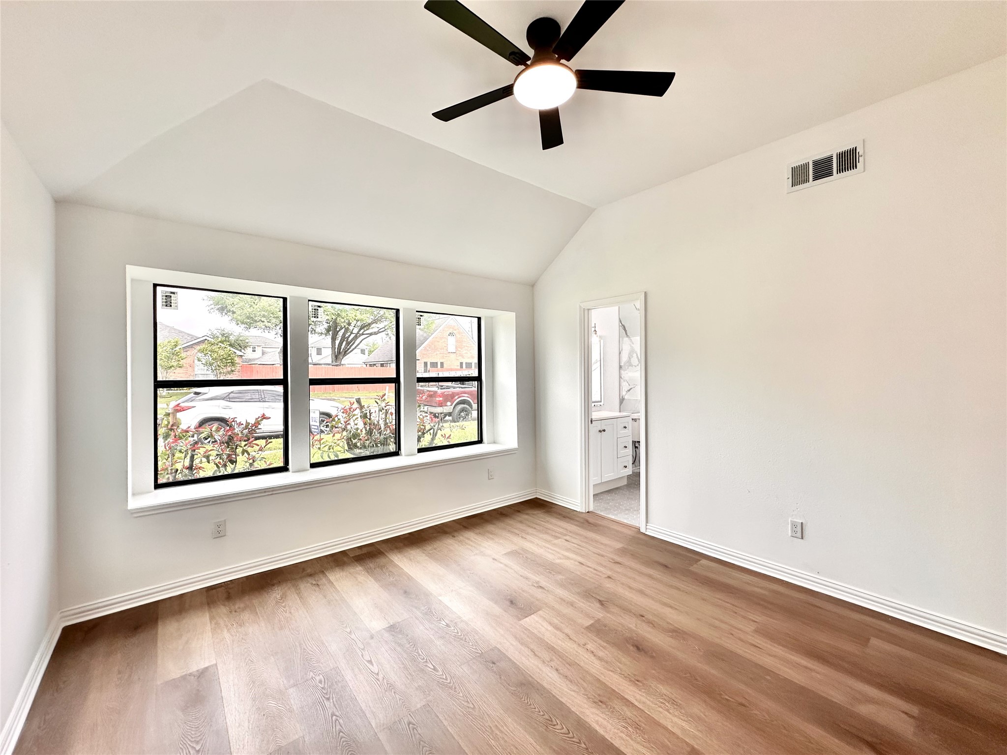 16411 Gold Ridge Lane Houston, TX 77053 - Photo 18 of 25 a view of an empty room with a window and wooden floor
