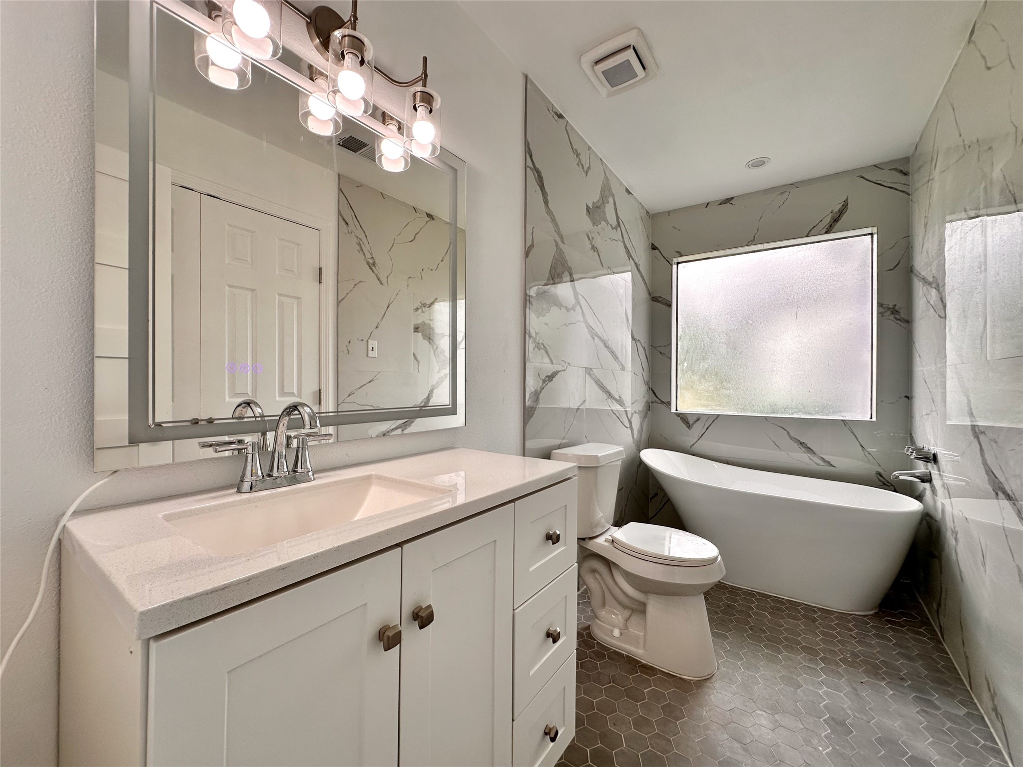 16411 Gold Ridge Lane Houston, TX 77053 - Photo 20 of 25 a bathroom with a double vanity sink mirror toilet and bathtub