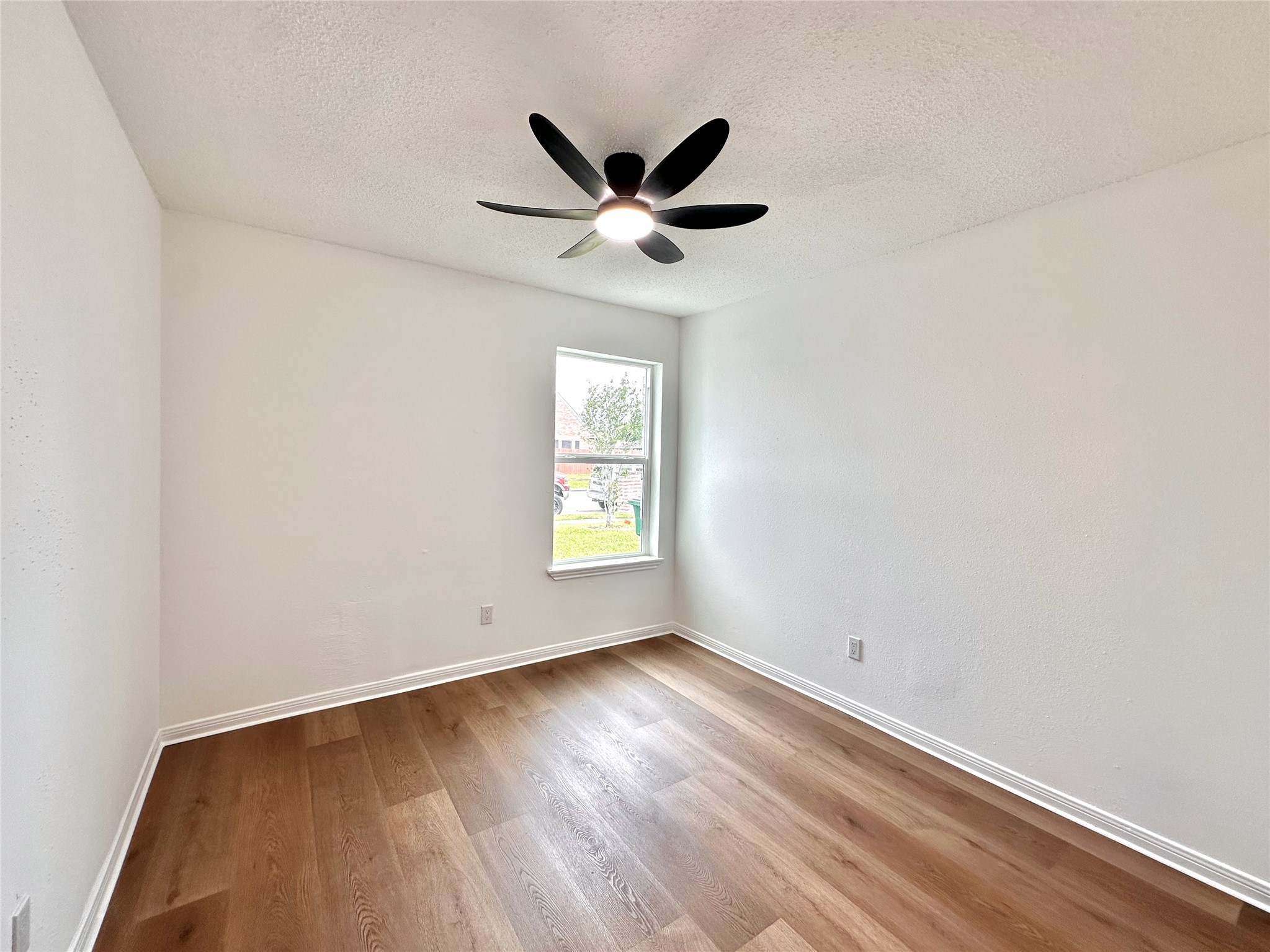 16411 Gold Ridge Lane Houston, TX 77053 - Photo 22 of 25 an empty room with wooden floor fan and windows