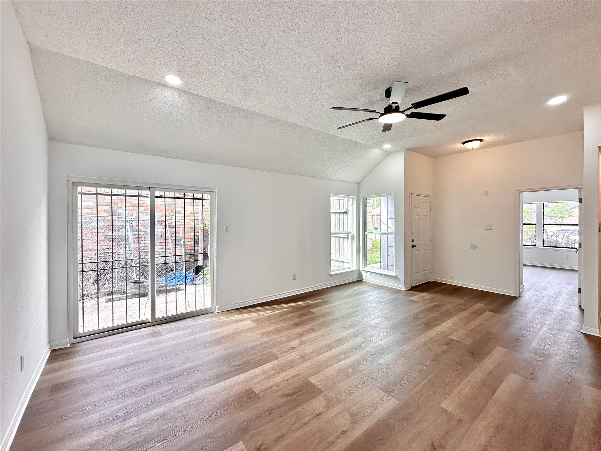 16411 Gold Ridge Lane Houston, TX 77053 - Photo 4 of 25 a view of an empty room with a window and wooden floor